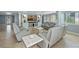 Bright and airy living room featuring comfortable seating, tile floors, and a built-in entertainment center at 2110 W Farwell Dr, Tampa, FL 33603