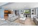 Open concept living room featuring tile floors, built in entertainment center and comfortable seating at 2110 W Farwell Dr, Tampa, FL 33603