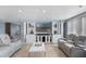 Open-concept living room featuring plush seating, a built-in entertainment center, and elegant tile flooring at 2110 W Farwell Dr, Tampa, FL 33603