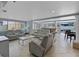 Spacious living room features comfortable seating, tile floors, a bar area, and access to the outdoors at 2110 W Farwell Dr, Tampa, FL 33603