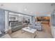 Spacious living room featuring light gray furniture, tile floors, and an open concept at 2110 W Farwell Dr, Tampa, FL 33603