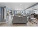 Spacious living room with plush seating, a built-in entertainment center, and access to an outdoor area at 2110 W Farwell Dr, Tampa, FL 33603