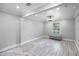Bright living room with wood-look floors, large window, and recessed lighting, creating a comfortable and inviting space at 2110 W Farwell Dr, Tampa, FL 33603