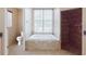 Bathroom featuring tiled floors, soaking tub, separate shower, and natural light at 2707 Wood Pointe Dr, Holiday, FL 34691