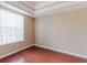 Bedroom with wood-look flooring, a large window, neutral paint color and decorative ceiling at 2707 Wood Pointe Dr, Holiday, FL 34691