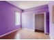 Bedroom with hardwood floors, lilac walls, and window with natural light at 2707 Wood Pointe Dr, Holiday, FL 34691