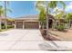 Charming single-story home with a well-maintained yard and three-car garage showcasing a well manicured lawn with palm trees at 2707 Wood Pointe Dr, Holiday, FL 34691