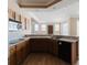 Traditional-style kitchen featuring wood cabinets, tile countertops, and modern appliances with an open floor plan at 2707 Wood Pointe Dr, Holiday, FL 34691