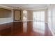 Spacious living room boasts gleaming hardwood floors and seamless access to an outdoor patio, perfect for entertaining guests at 2707 Wood Pointe Dr, Holiday, FL 34691