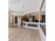 Open-concept living room featuring hardwood floors and a view of the kitchen at 2707 Wood Pointe Dr, Holiday, FL 34691