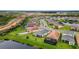 Aerial view of the neighborhood showcasing spacious lawns, backyard pools, and construction in progress nearby at 32740 Tree Of Life Ave, Wesley Chapel, FL 33543