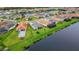 Aerial view of homes and a lake showcasing serene waterfront living at 32740 Tree Of Life Ave, Wesley Chapel, FL 33543