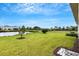 Lush backyard with pond view, pool, and ample green space at 32740 Tree Of Life Ave, Wesley Chapel, FL 33543