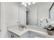 Elegant bathroom features a frameless shower and single sink vanity with quartz countertops and white cabinets at 32740 Tree Of Life Ave, Wesley Chapel, FL 33543