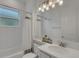 Cozy bathroom features a shower-tub combo, single sink vanity, neutral paint, and tile flooring at 32740 Tree Of Life Ave, Wesley Chapel, FL 33543