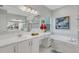 Bright bathroom features a soaking tub, frameless shower, double sink vanity, and quartz countertops at 32740 Tree Of Life Ave, Wesley Chapel, FL 33543