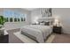 Bedroom with a large window, neutral decor, and a comfortable-looking bed and matching nightstands at 32740 Tree Of Life Ave, Wesley Chapel, FL 33543