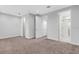 Carpeted bedroom with hallway, closet, and bathroom access at 32740 Tree Of Life Ave, Wesley Chapel, FL 33543