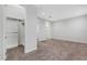 Carpeted bedroom with walk-in closet and a partial bathroom view at 32740 Tree Of Life Ave, Wesley Chapel, FL 33543