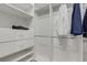 Walk in closet with built in shelves and clothes rods at 32740 Tree Of Life Ave, Wesley Chapel, FL 33543