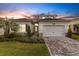 Beautiful single-Gathering home with a well-manicured lawn at dusk at 32740 Tree Of Life Ave, Wesley Chapel, FL 33543