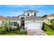 Beautiful two-story home with landscaped front yard and brick paver driveway at 32740 Tree Of Life Ave, Wesley Chapel, FL 33543