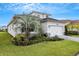 Charming home exterior with a well-manicured lawn and beautiful landscaping at 32740 Tree Of Life Ave, Wesley Chapel, FL 33543