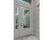 Elegant white front door with decorative glass panels and marble flooring at 32740 Tree Of Life Ave, Wesley Chapel, FL 33543