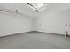 Large garage with epoxy flooring, door to house and garage door opener at 32740 Tree Of Life Ave, Wesley Chapel, FL 33543