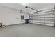 Spacious two car garage with epoxy floor and garage door opener at 32740 Tree Of Life Ave, Wesley Chapel, FL 33543
