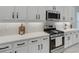 Close up of kitchen with stainless steel appliances, white cabinets, and modern backsplash at 32740 Tree Of Life Ave, Wesley Chapel, FL 33543