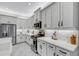Modern kitchen featuring white cabinets, stainless steel appliances, and tiled backsplash at 32740 Tree Of Life Ave, Wesley Chapel, FL 33543
