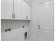 Functional laundry room featuring cabinetry, a sink, and laundry hookups at 32740 Tree Of Life Ave, Wesley Chapel, FL 33543