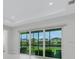 Bright living room with sliding glass doors showcasing beautiful outdoor views at 32740 Tree Of Life Ave, Wesley Chapel, FL 33543