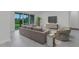Living room with sliding glass doors leading to the patio and a comfortable seating area at 32740 Tree Of Life Ave, Wesley Chapel, FL 33543