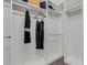 Stylish walk-in closet with shelving and hanging rods, featuring custom storage solutions and neutral decor at 32740 Tree Of Life Ave, Wesley Chapel, FL 33543