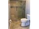 Bathroom featuring a walk-in shower with glass door and subway tile surround at 420 S Brockfield Dr, Sun City Center, FL 33573