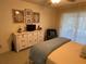 Comfortable bedroom featuring a dresser, TV, and sliding glass door at 420 S Brockfield Dr, Sun City Center, FL 33573