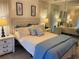 Relaxing bedroom featuring a comfortable bed, nightstands, and mirrored wall at 420 S Brockfield Dr, Sun City Center, FL 33573