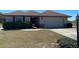 Well-maintained single-story home with a two-car garage and landscaping at 420 S Brockfield Dr, Sun City Center, FL 33573
