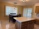 Bright eat-in kitchen featuring an island, a dark wood table, and abundant natural light at 420 S Brockfield Dr, Sun City Center, FL 33573