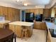 Kitchen featuring natural wood cabinetry, light countertops, an island, and tile flooring at 420 S Brockfield Dr, Sun City Center, FL 33573