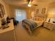 Comfortable bedroom featuring neutral decor, a ceiling fan, and abundant natural light from sliding glass doors at 420 S Brockfield Dr, Sun City Center, FL 33573