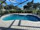 Inviting screened-in pool with brick paver surround, ideal for relaxation and entertainment at 420 S Brockfield Dr, Sun City Center, FL 33573