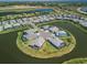 Aerial view showcasing waterfront homes with lush landscaping in a serene and upscale neighborhood at 4754 Manning Ct, Sarasota, FL 34240
