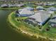 Beautiful aerial view of a waterfront home with a screened-in pool in a landscaped community at 4754 Manning Ct, Sarasota, FL 34240