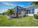 Beautiful backyard featuring a screened-in pool, lush lawn, and water views, creating a private oasis at 4754 Manning Ct, Sarasota, FL 34240