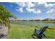 Enjoy peaceful waterfront views from the backyard, featuring a tranquil seating area at 4754 Manning Ct, Sarasota, FL 34240