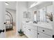 Bathroom featuring white cabinetry, quartz countertop, and a decorative mirror at 4754 Manning Ct, Sarasota, FL 34240