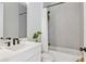 Bathroom with gray tiling, white vanity, matte black fixtures, and a shower-tub combo at 4754 Manning Ct, Sarasota, FL 34240